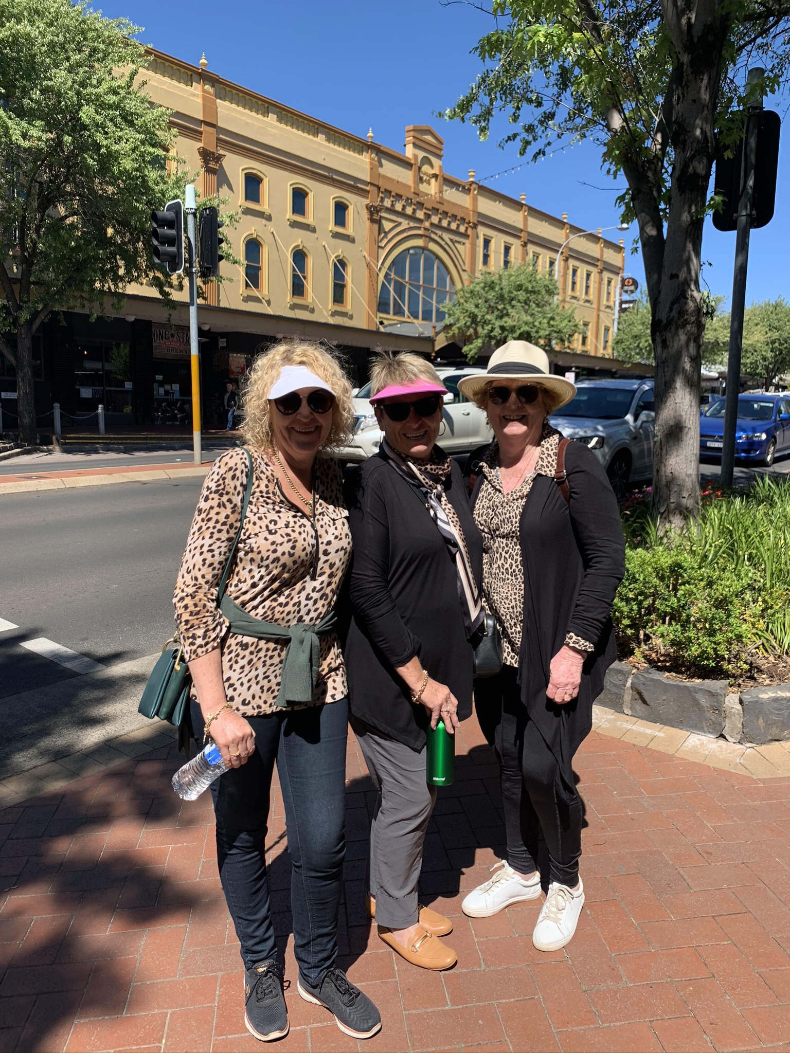 3 ladies standing in front of historic building