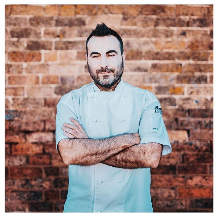 photo of chef Ruben standing in front of brick wall